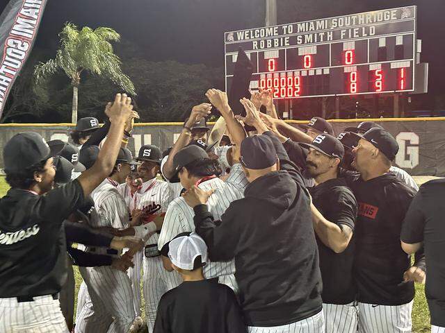 Southridge baseball coaches and players celebrate on Thursday night at Robbie Smith Field after winning their first GMAC championship since 2001.